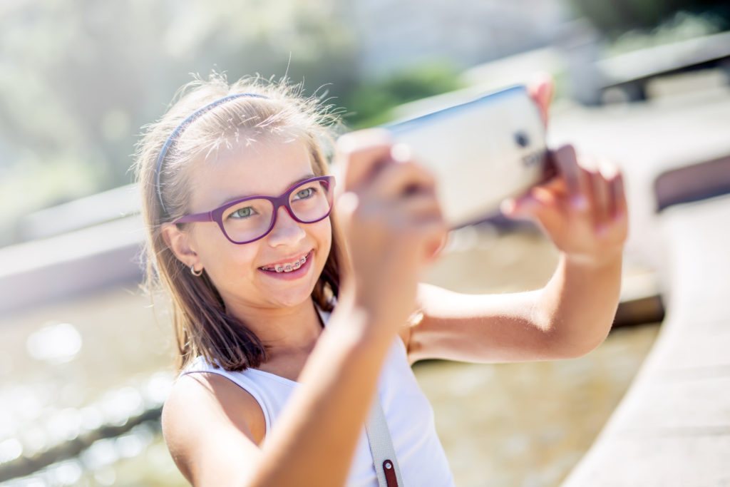 young girl smiling taking selfies