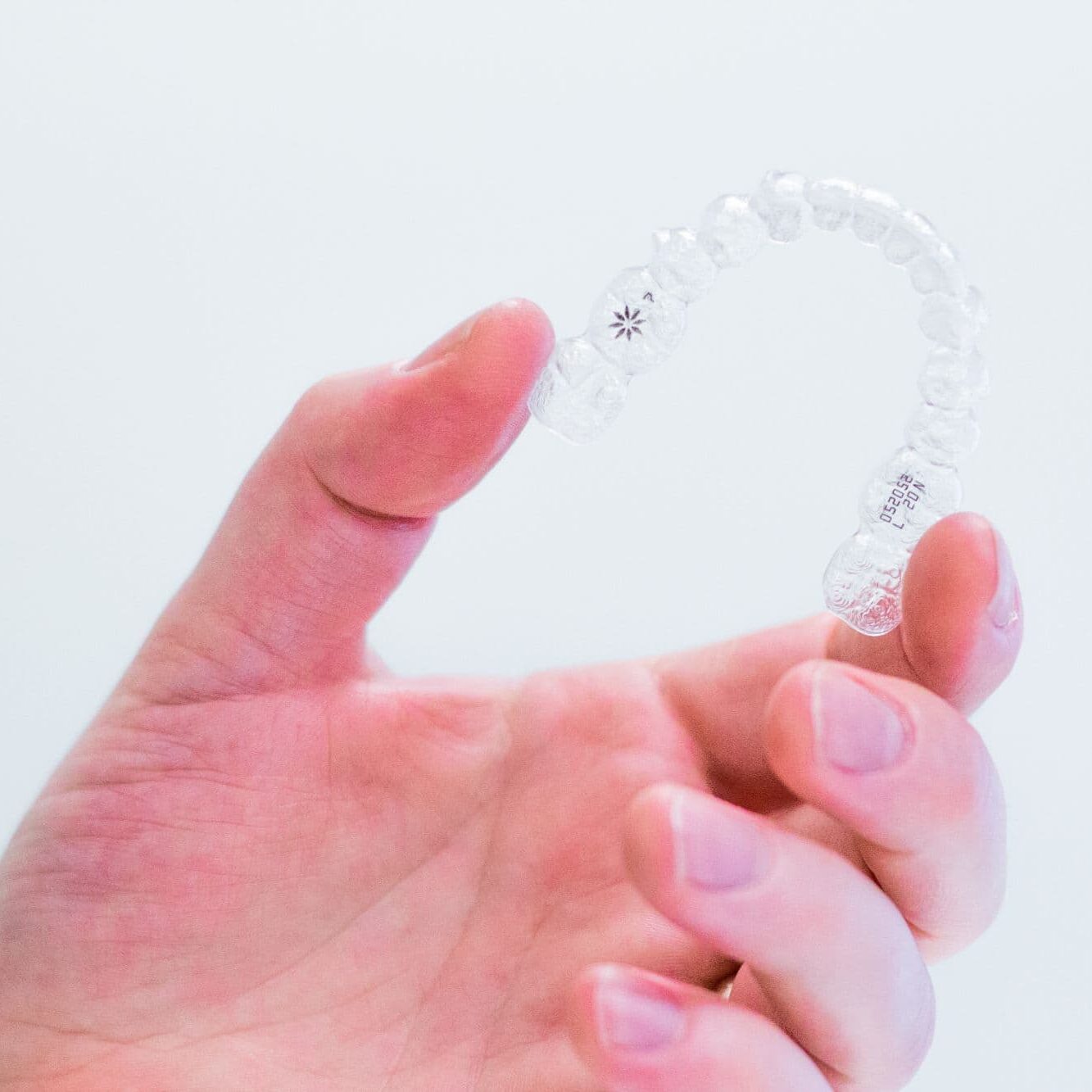 hand-holding-invisalign-aligners long beach invisalign